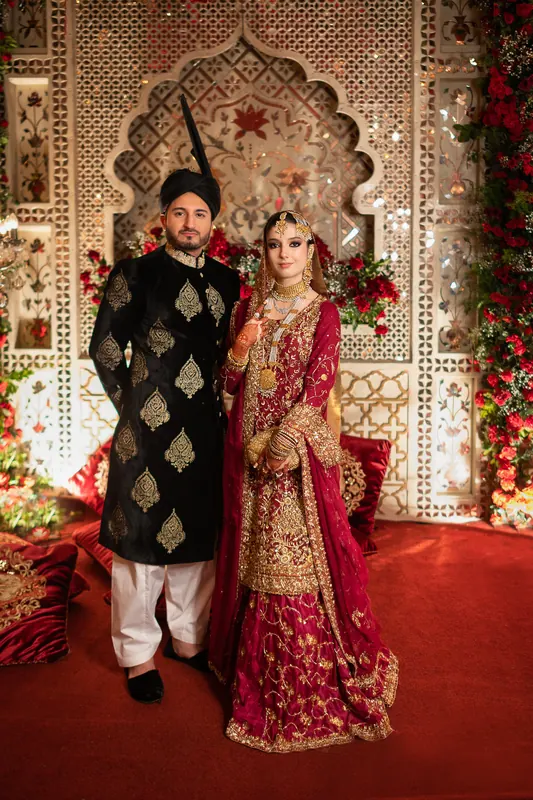 Guests gathered on an elegantly lit stage at a Pakistani wedding reception in Islamabad